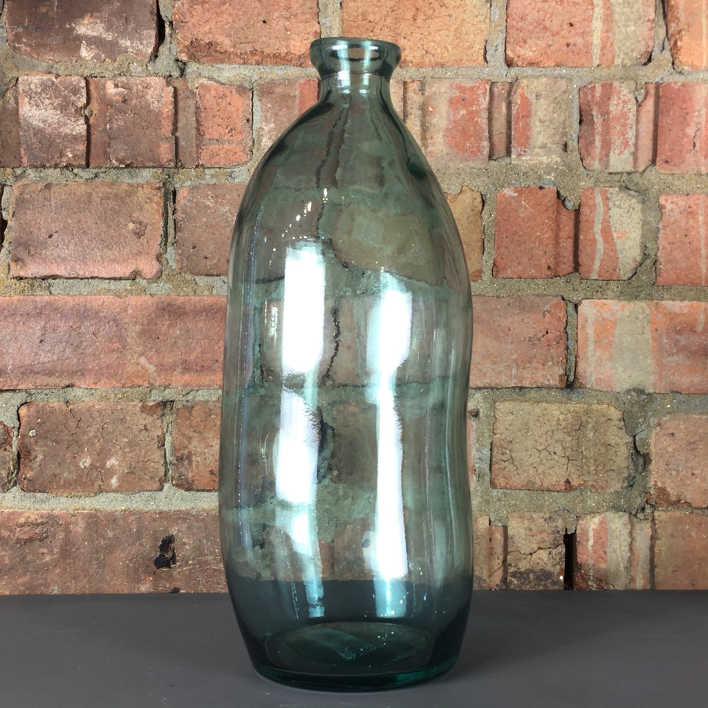 Tall rustic vase/ bottle in coloured glass. 