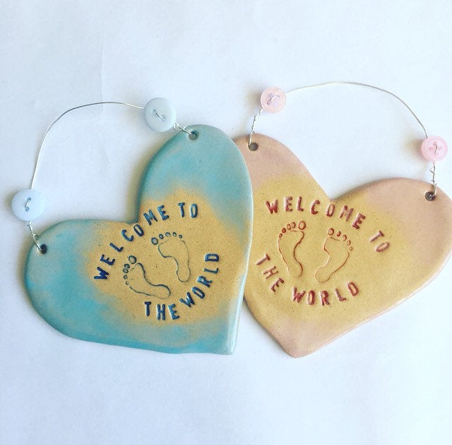 Welcome to the world hanging heart in blue and pink.