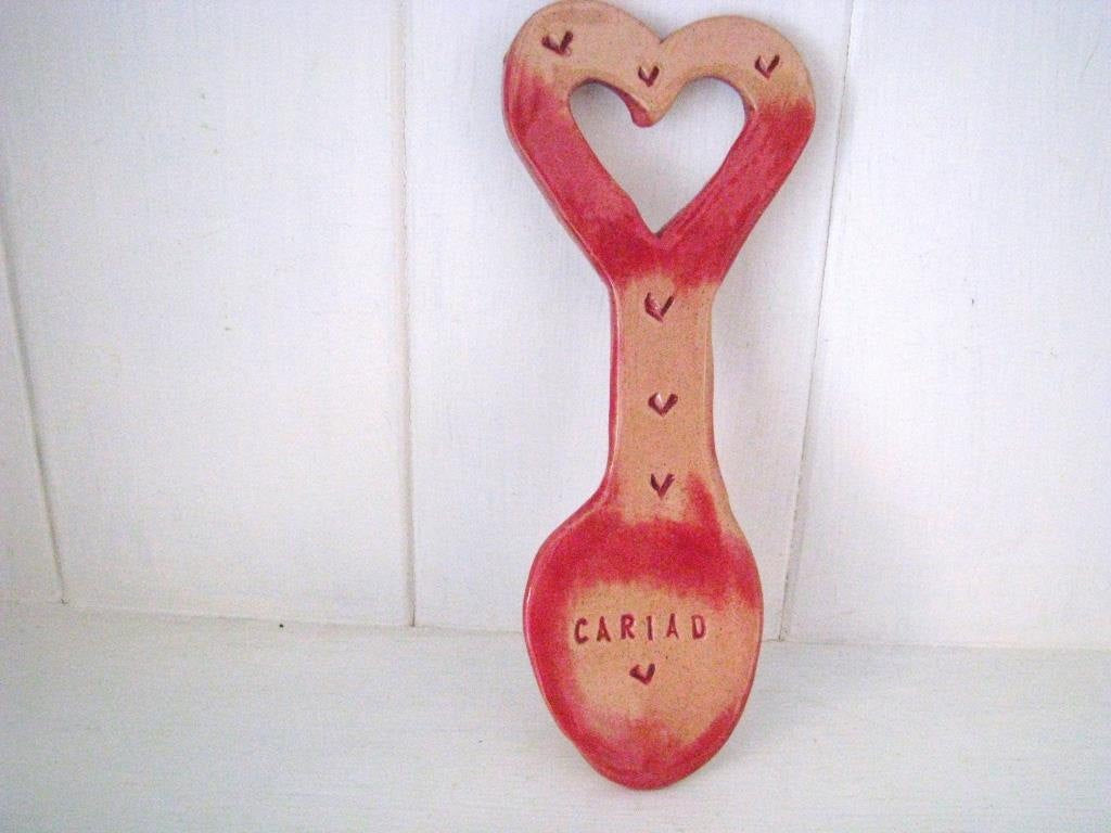 ceramic Welsh Lovespoon decorated with the word cariad and hearts