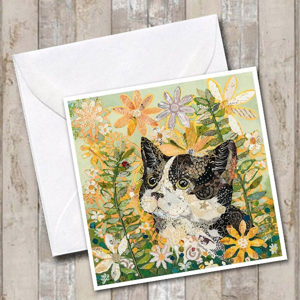 Greetings card with an image of a cat amongst wildflowers looking at a ladybird.