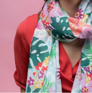 Lightweight Women's scarf with pastel flowers and tropical leaves on a white background. designed scarf