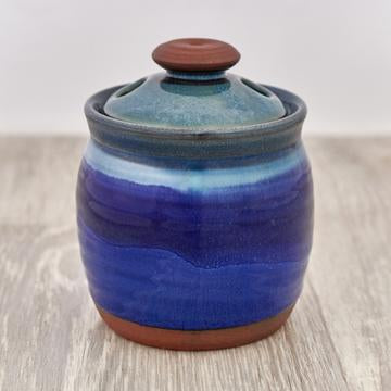 Pot for storing garlic in blue witrh tirquoise and clay brown lid.