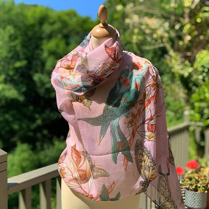 pink summer scarf with a bird and butterfly design. Turquoise, orange and pale yellow accents.