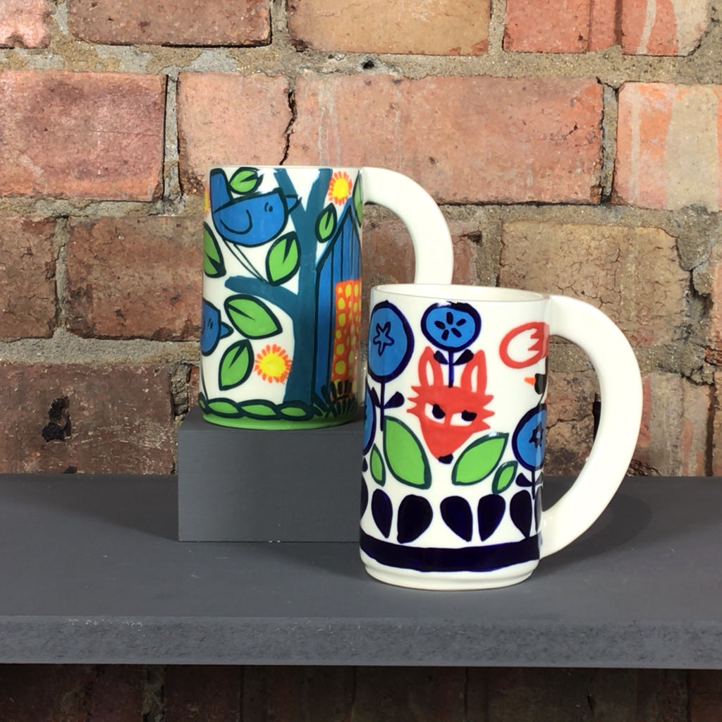 Large handled mug with abstract blue bird or red fox design.