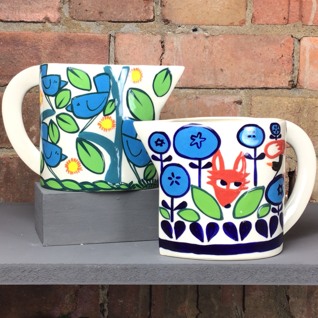 Handmade jug available in two designs, one with a fox, the other with blue birds.