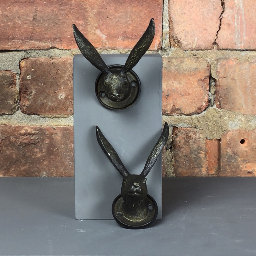 Metal hare hook for hanging items on in black.