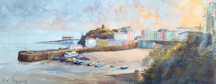 Print of Tenby Harbour during the evening with the tide out and multiple boats in the bay.