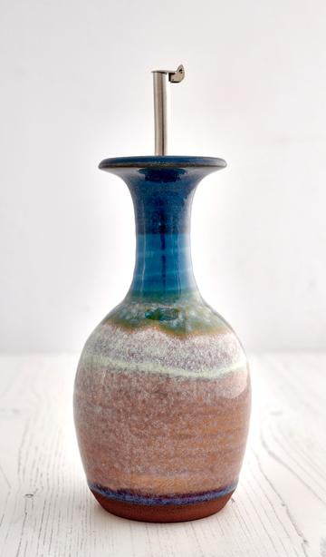 olive oli decanter in stoneware blue, green and brown.