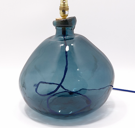 Cobalt blue wide bottomed bottle shaped glass lamp base with fabric covered cord and three pin plug.
