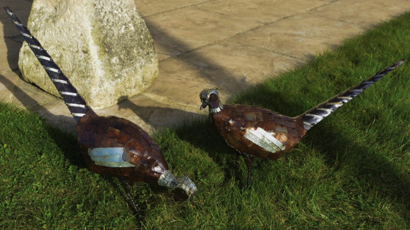 Pair of pheasant sculptures made from recycled metal by fairtrade artists.