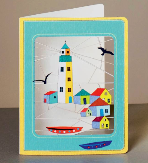 Lazercut greetings card of a lighthouse and cottages.