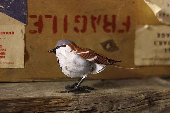 Recycled metal sparrow in white and dark brown.
