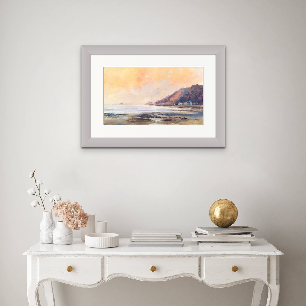 View of print of Mumbles in frame above a console table